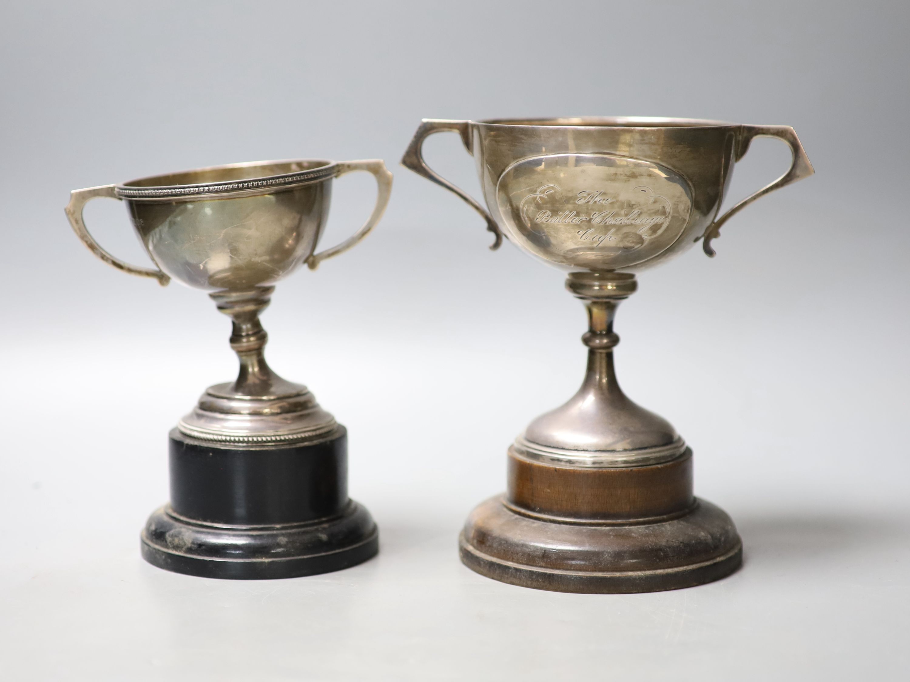 Two early to mid 20th century silver two handled presentation trophy cups, tallest 14cm (a.f.)